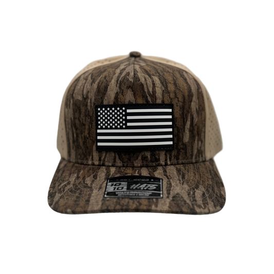 Camouflage cap with American flag patch on a white background